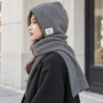 Side view of the grey FrostHood knitted hooded scarf covering head and neck