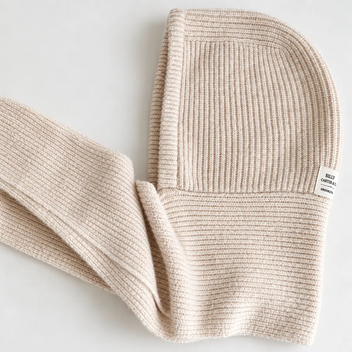 Close-up of the beige FrostHood ribbed knit and connected hood and scarf