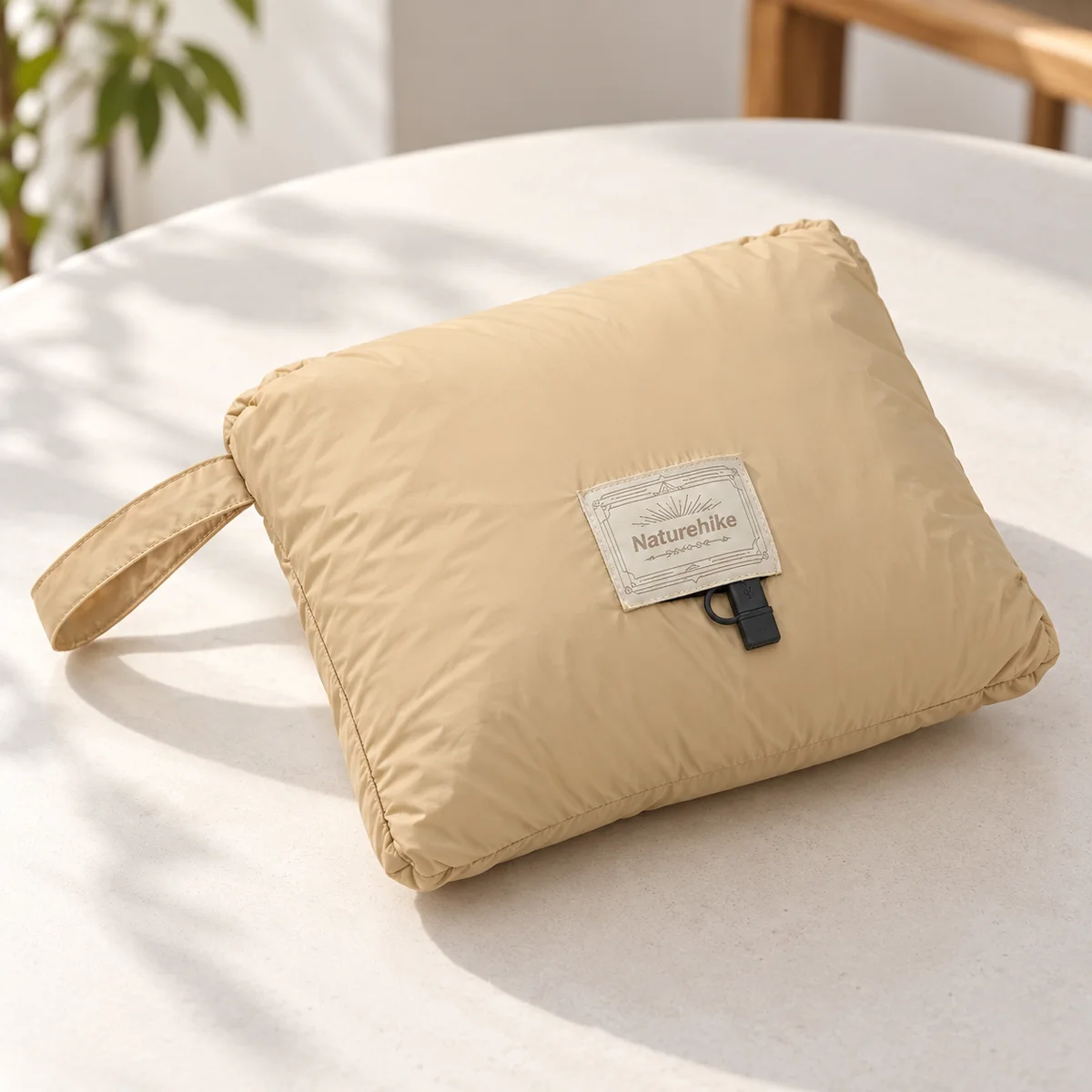 Naturehike camping blanket folded into its integrated storage pocket with carry handle