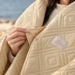 Close-up of Naturehike camping blanket diamond quilting and snap fastenings