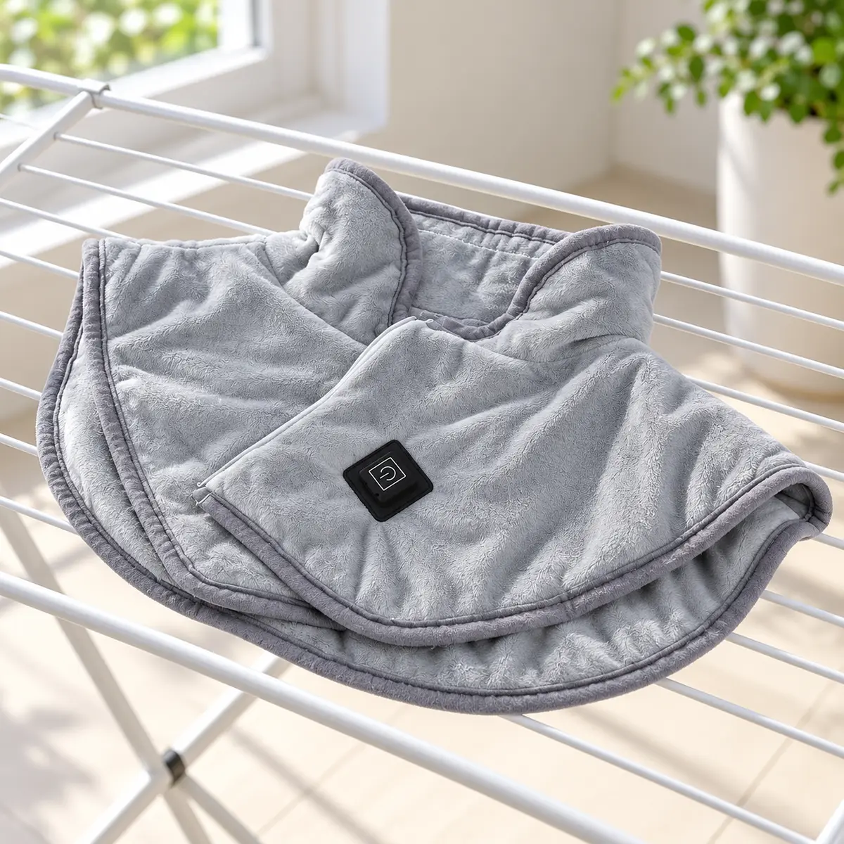 Unplugged ShoulderEase heated wrap air drying on a rack